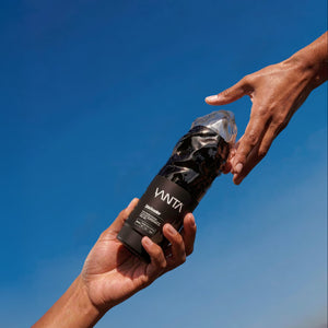 Two hands reaching towards each other with a Vanta product against a blue sky.